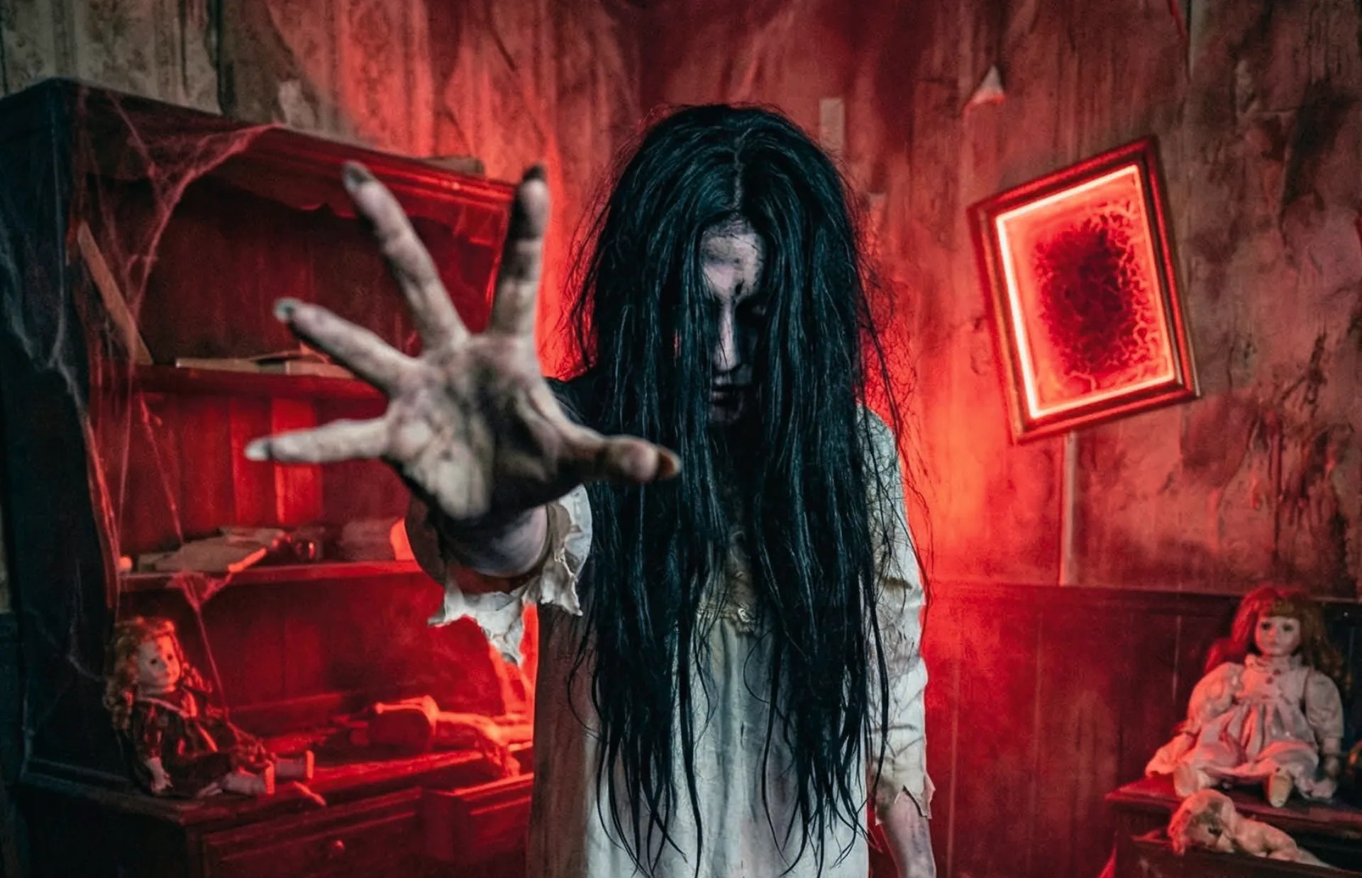 Cathy reaching out of the red room in The Possession